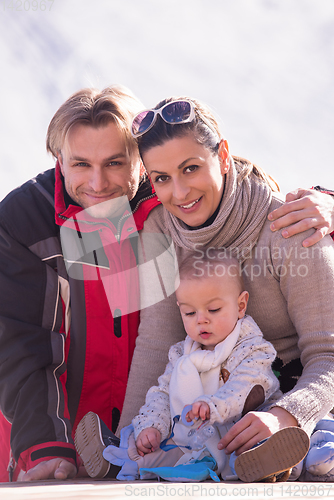 Image of young happy family with little child enjoying winter day