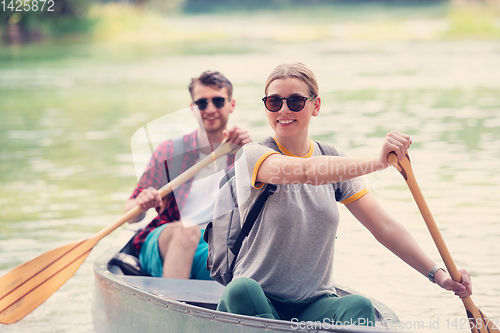 Image of couple of explorers conoining on wild river