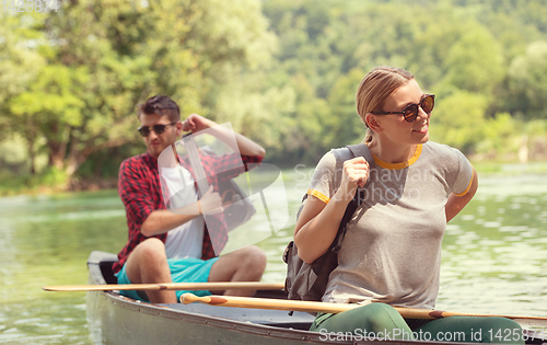 Image of couple of explorers conoining on wild river