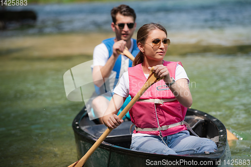 Image of couple of conoining on wild river