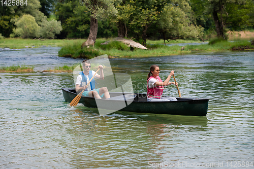 Image of couple of conoining on wild river