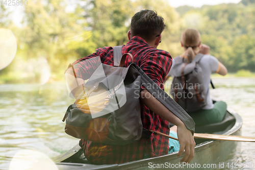 Image of couple of explorers conoining on wild river