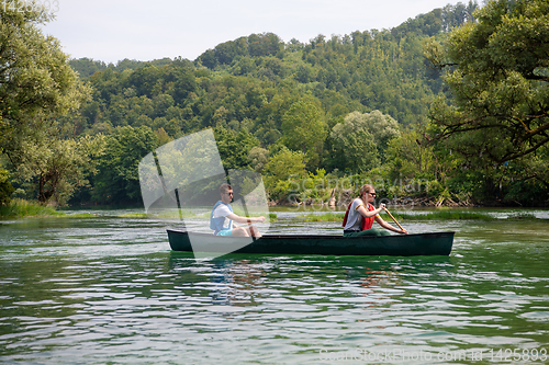 Image of couple of explorers conoining on wild river