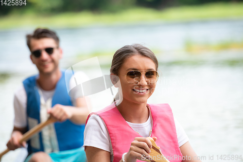 Image of couple of conoining on wild river