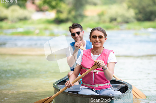 Image of couple of conoining on wild river