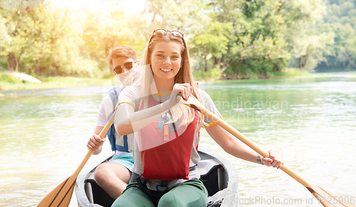 Image of couple of explorers conoining on wild river