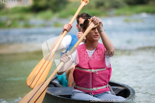 Image of couple of conoining on wild river