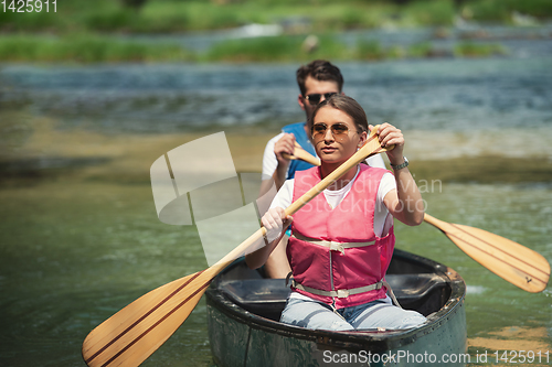 Image of couple of conoining on wild river