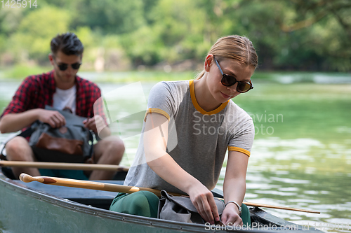 Image of couple of explorers conoining on wild river