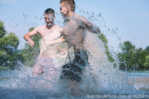 Image of summer joy friends having fun on river