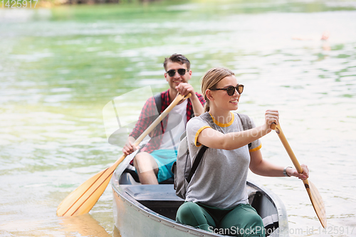 Image of couple of explorers conoining on wild river