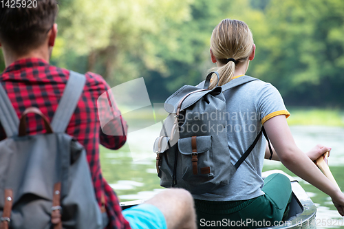 Image of couple of explorers conoining on wild river