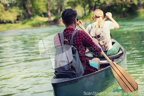 Image of couple of explorers conoining on wild river