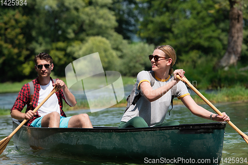 Image of couple of explorers conoining on wild river