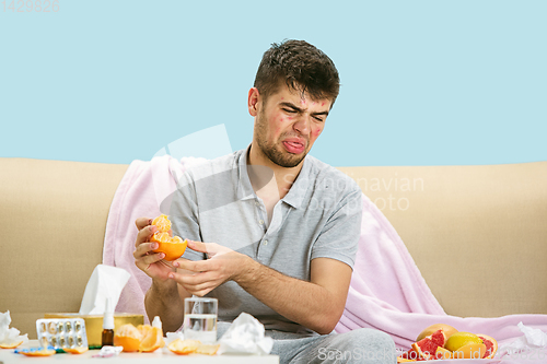 Image of Young man suffering from allergy to citrus fruits