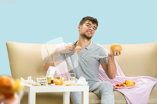 Image of Young man suffering from allergy to citrus fruits