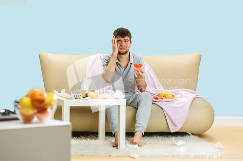 Image of Young man suffering from allergy to citrus fruits