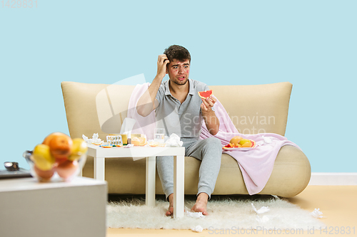 Image of Young man suffering from allergy to citrus fruits