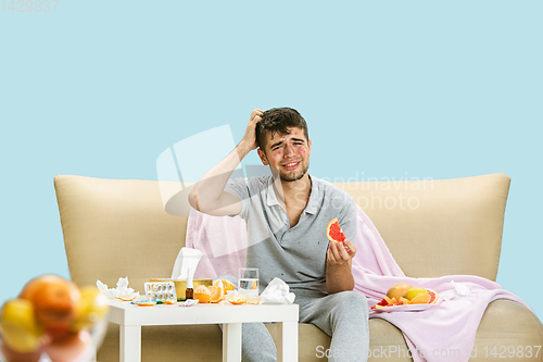 Image of Young man suffering from allergy to citrus fruits