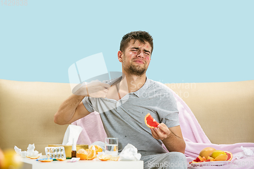Image of Young man suffering from allergy to citrus fruits