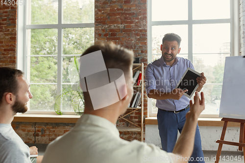 Image of Male speaker giving presentation in hall at university workshop