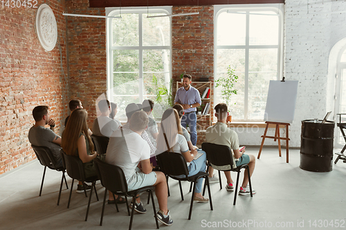 Image of Male speaker giving presentation in hall at university workshop