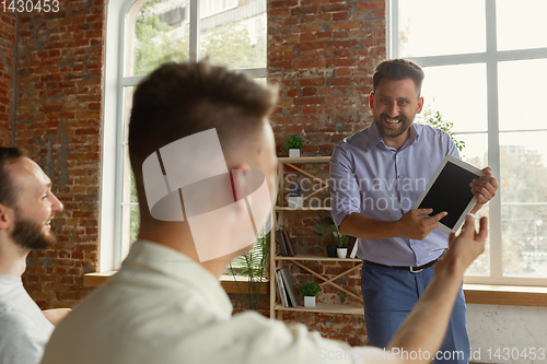 Image of Male speaker giving presentation in hall at university workshop