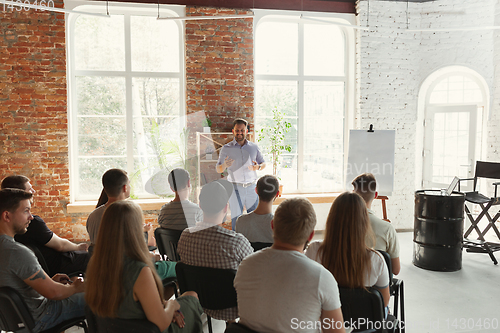 Image of Male speaker giving presentation in hall at university workshop