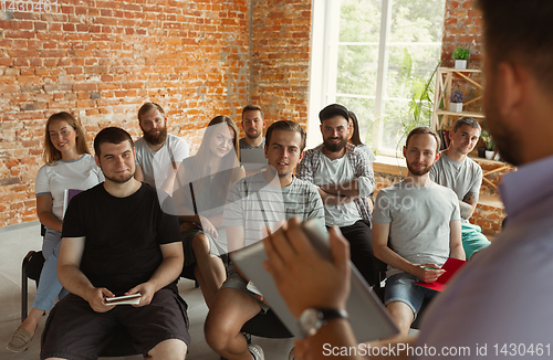 Image of Male speaker giving presentation in hall at university workshop