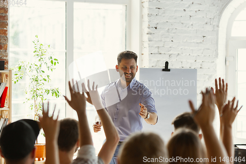 Image of Male speaker giving presentation in hall at university workshop