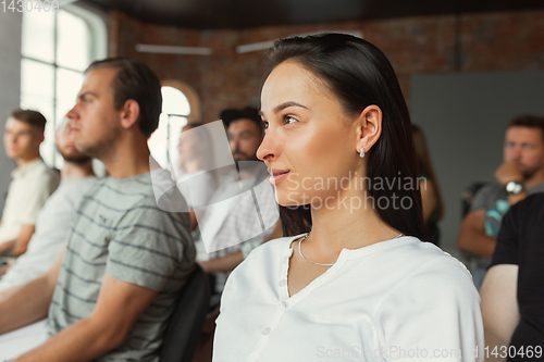 Image of Students listening to presentation in hall at university workshop