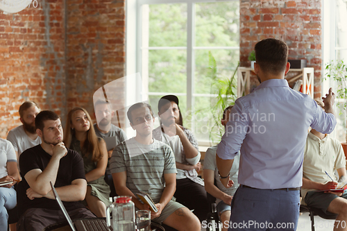 Image of Male speaker giving presentation in hall at university workshop