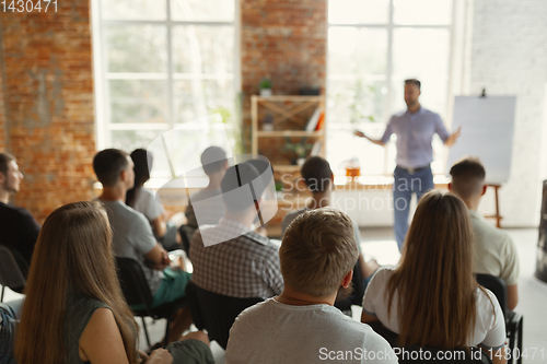 Image of Male speaker giving presentation in hall at university workshop