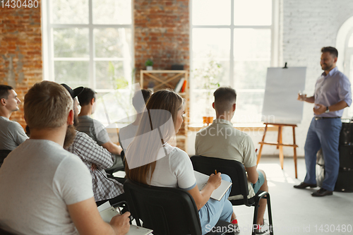 Image of Male speaker giving presentation in hall at university workshop