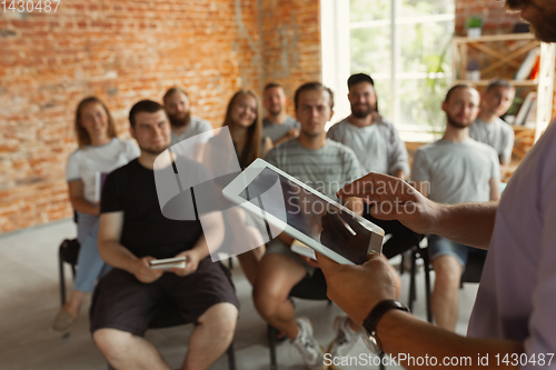 Image of Male speaker giving presentation in hall at university workshop