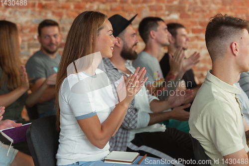 Image of Students listening to presentation in hall at university workshop