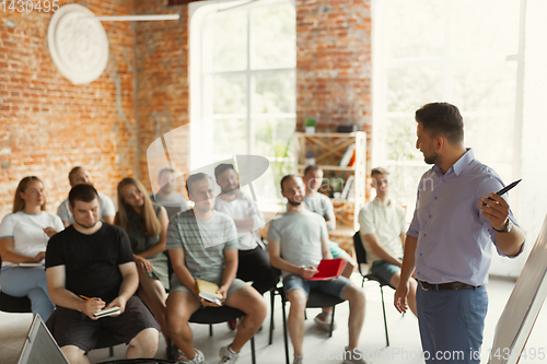 Image of Male speaker giving presentation in hall at university workshop