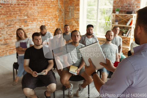 Image of Male speaker giving presentation in hall at university workshop