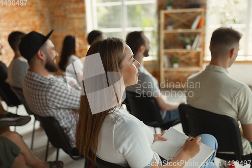 Image of Students listening to presentation in hall at university workshop