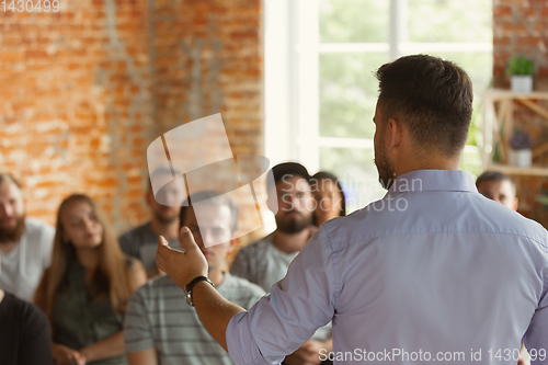 Image of Male speaker giving presentation in hall at university workshop