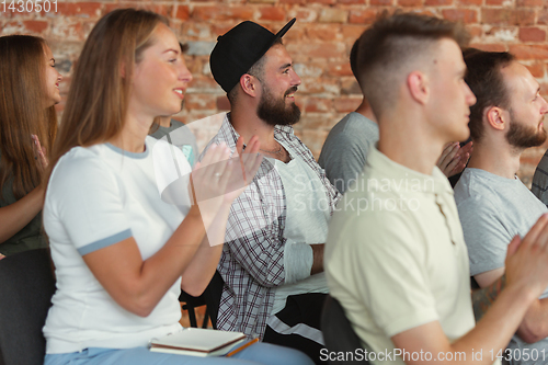 Image of Students listening to presentation in hall at university workshop