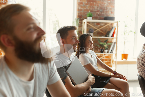 Image of Students listening to presentation in hall at university workshop