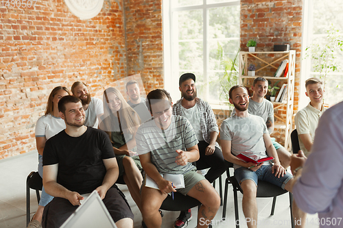 Image of Students listening to presentation in hall at university workshop