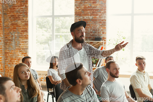 Image of Male speaker giving presentation in hall at university workshop