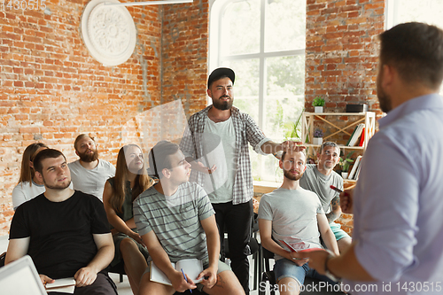 Image of Male speaker giving presentation in hall at university workshop