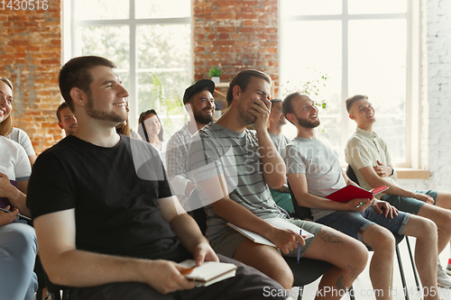 Image of Students listening to presentation in hall at university workshop