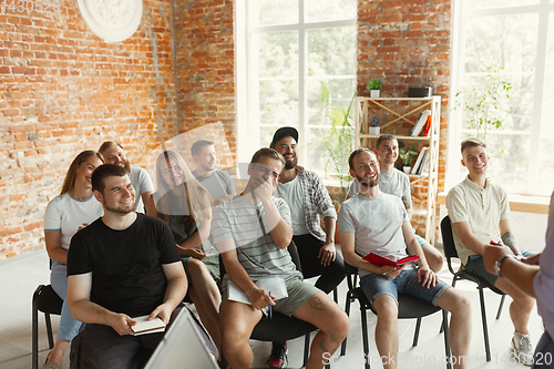 Image of Students listening to presentation in hall at university workshop