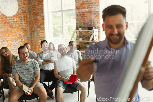 Image of Male speaker giving presentation in hall at university workshop