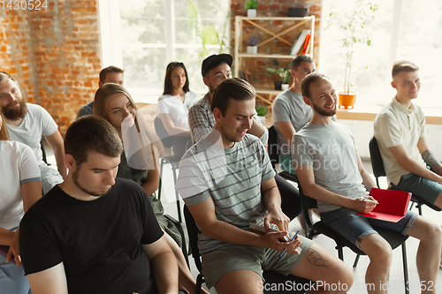 Image of Students listening to presentation in hall at university workshop