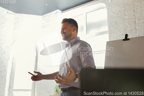 Image of Male speaker giving presentation in hall at university workshop